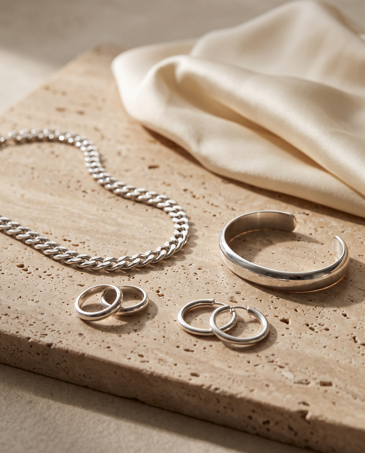 Tess & Mae Silver Jewelry on warm beige travertine