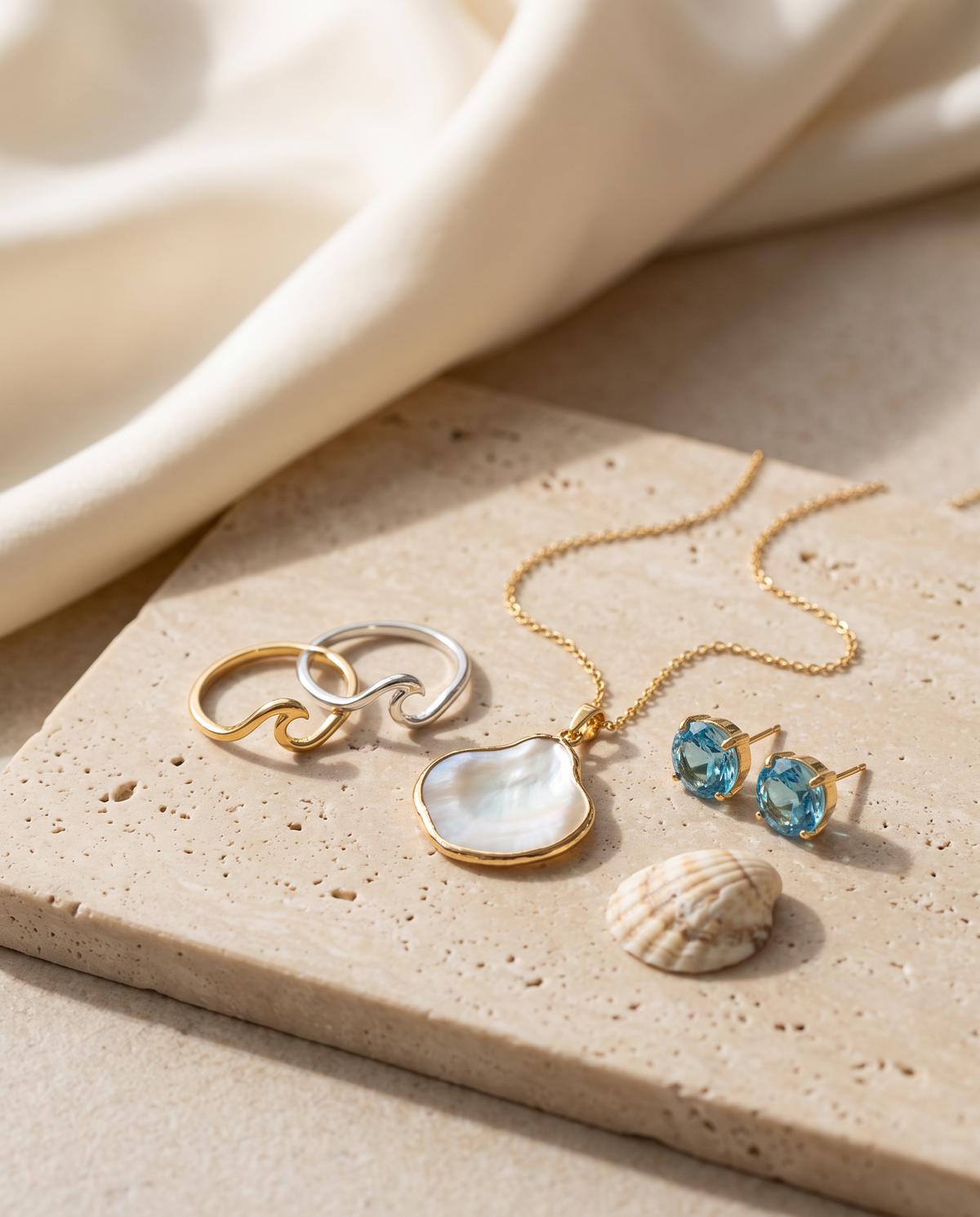 Tess & Mae Ocean Jewelry on warm beige travertine